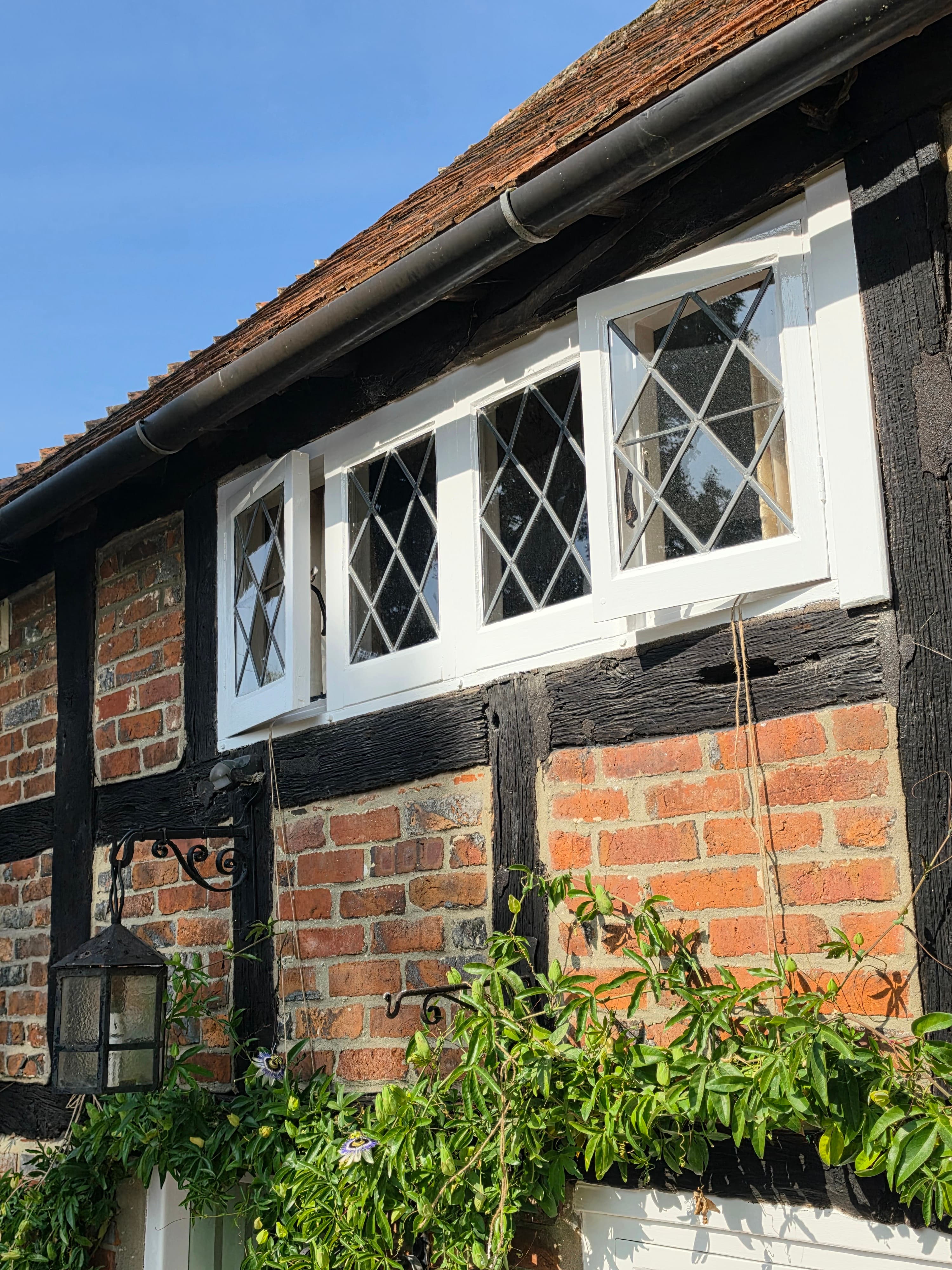 Freshly painted leaded window frames on a period timber-framed property — PJW Decorators
